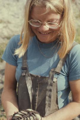 Archaeologist holding artifact