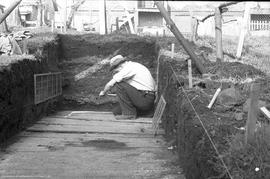 Archaeoloigst drawing profile in trench