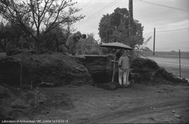 Archaeologists standing under umbrella at Locarno Beach site