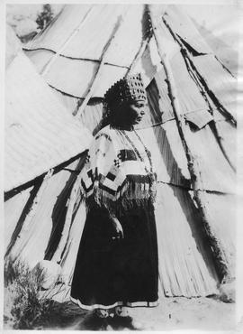 Traditional dress in front of Teepee