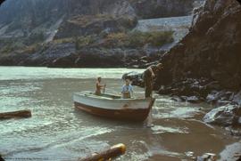 R. Cox, D. Smith, and D. Macleod in boat at swimming beach